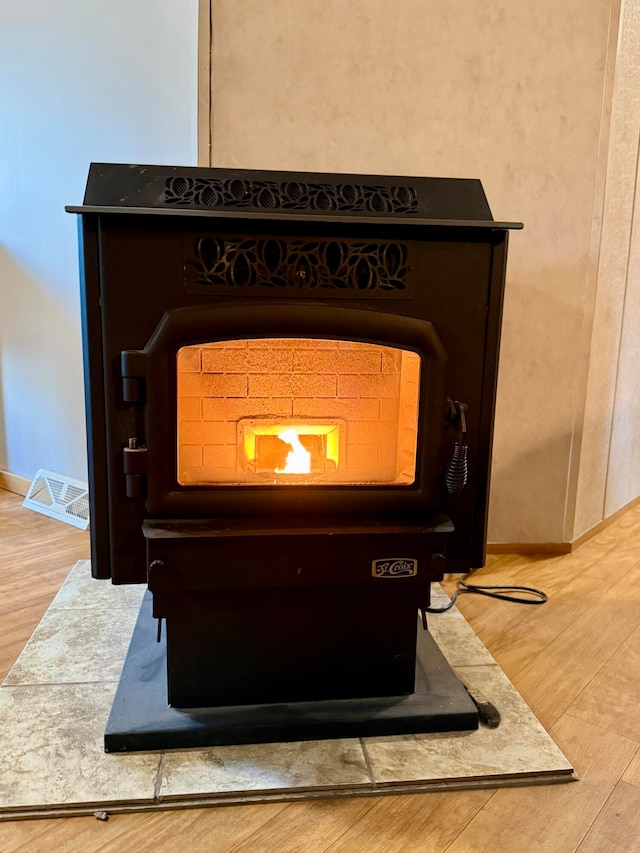 details with wood-type flooring and a wood stove