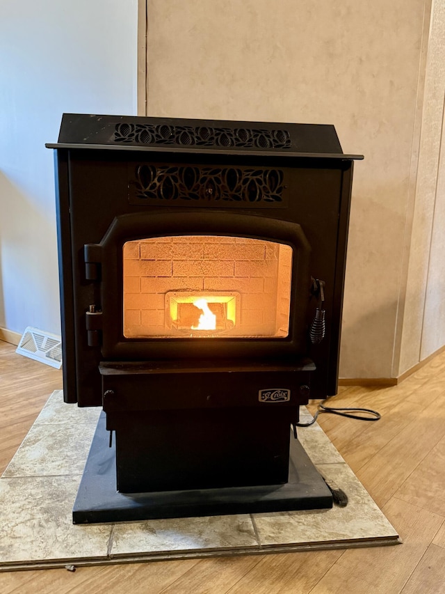 526 Darling Rd, Hudson, ME 04449 - detailed view of a wood stove, wood finished floors, and baseboards