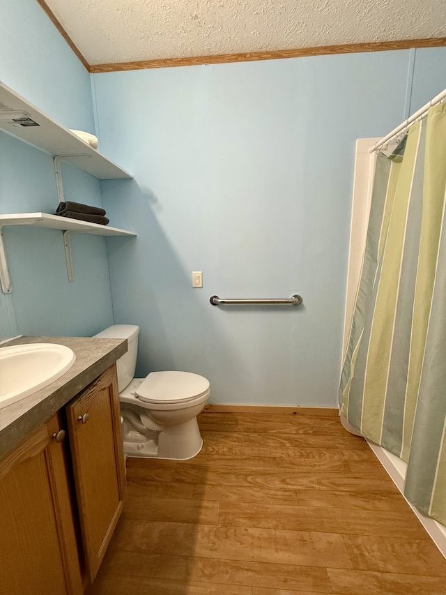 526 Darling Rd, Hudson, ME 04449 - full bathroom featuring wood finished floors, toilet, vanity, crown molding, and a textured ceiling