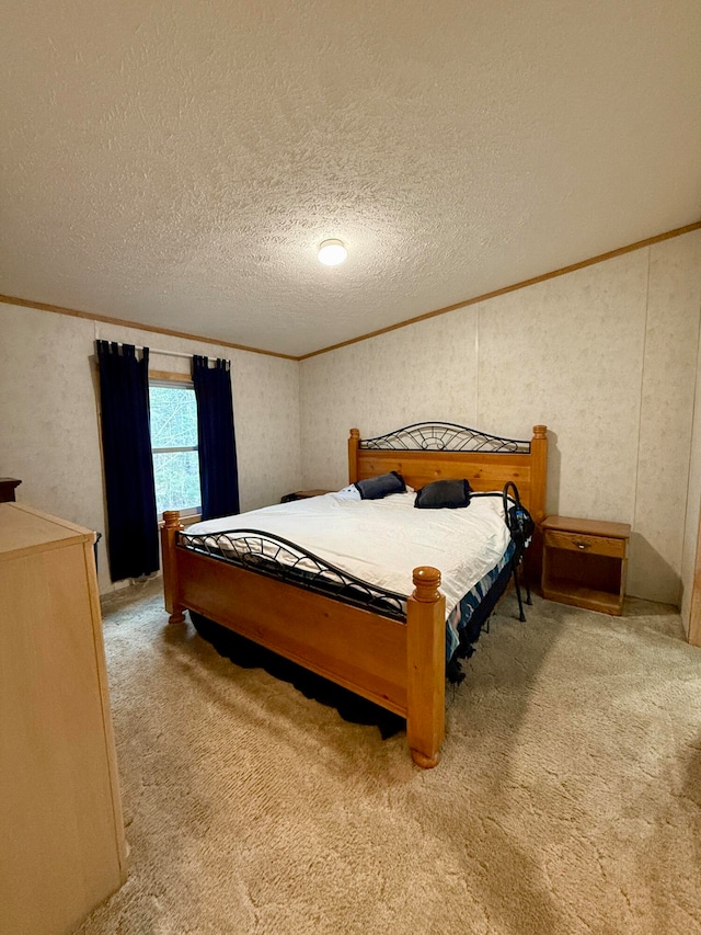 bedroom with carpet flooring, ornamental molding, and a textured ceiling