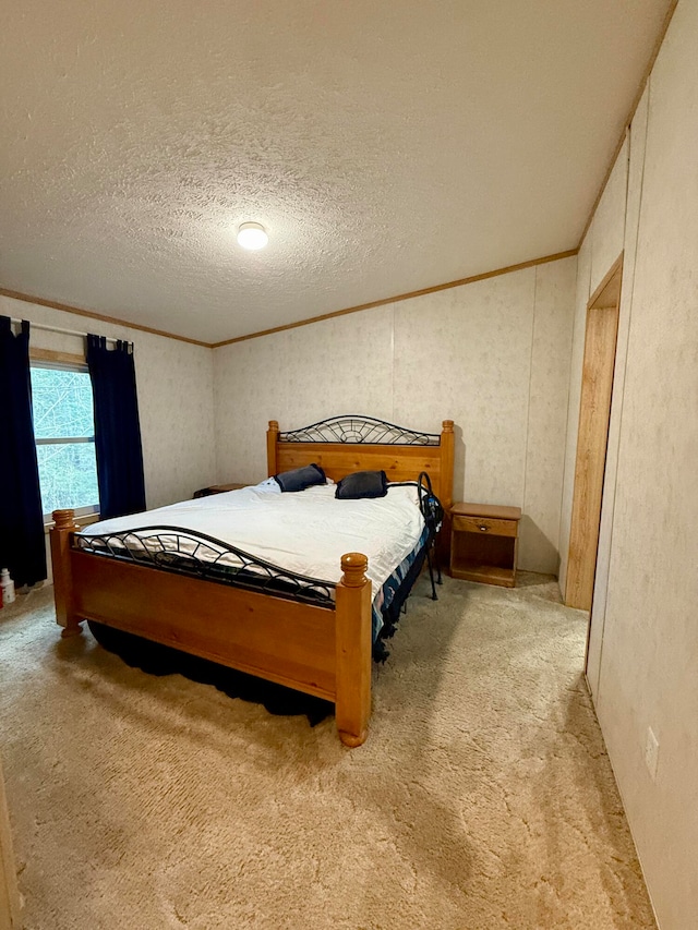 bedroom featuring carpet flooring, ornamental molding, and a textured ceiling