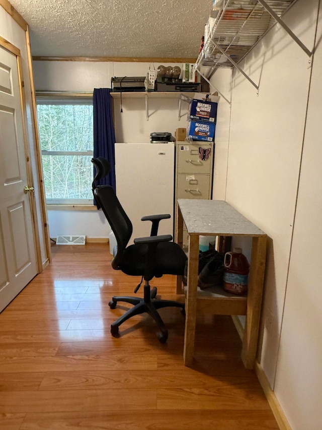 office featuring hardwood / wood-style floors and a textured ceiling