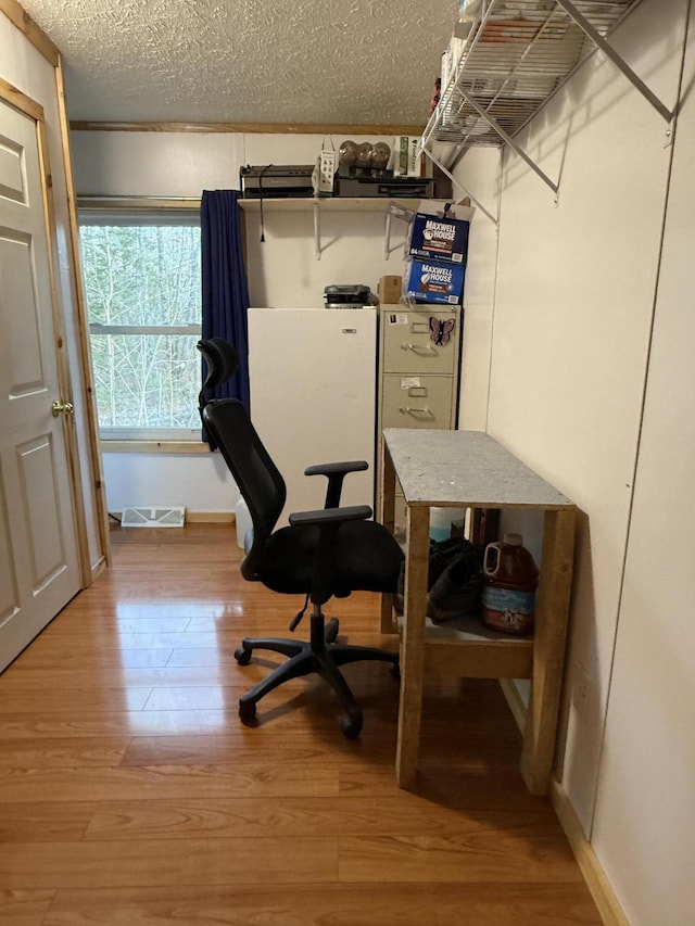 526 Darling Rd, Hudson, ME 04449 - office space featuring light wood-type flooring, a textured ceiling, and baseboards