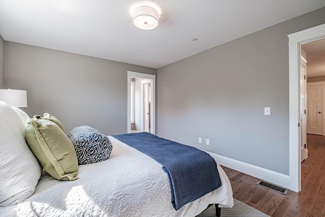 bedroom with hardwood / wood-style floors