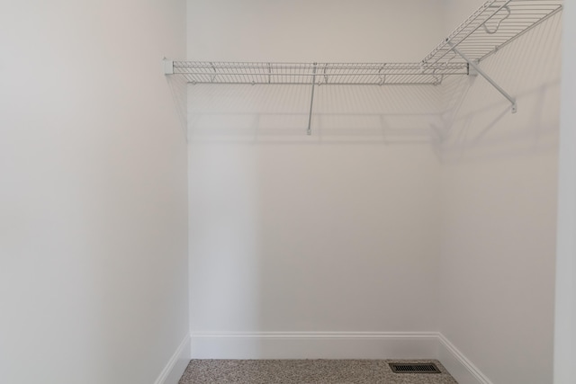 walk in closet featuring carpet