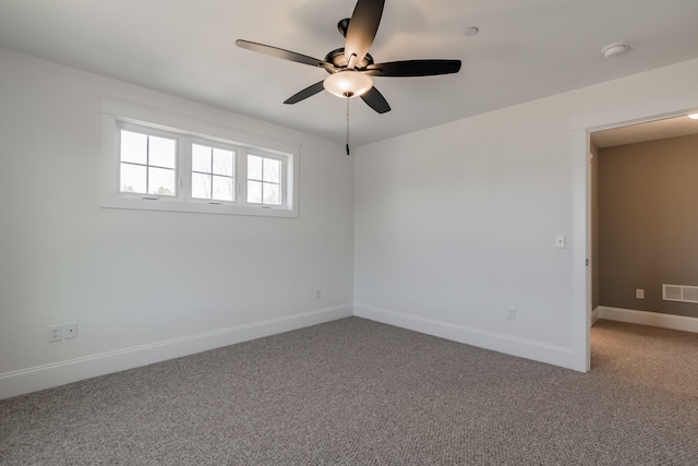 carpeted spare room featuring ceiling fan