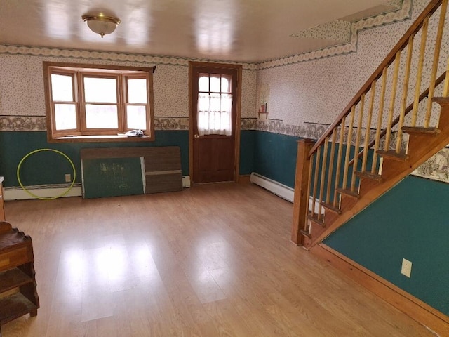 foyer with wood-type flooring and a baseboard radiator