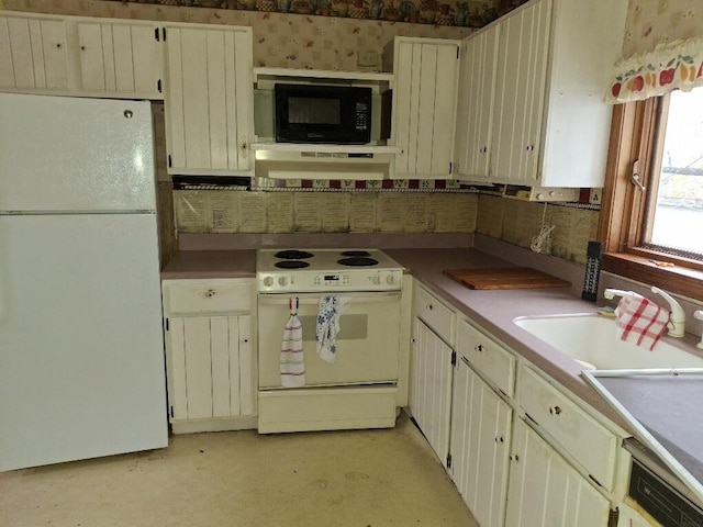 kitchen with sink, white appliances, and cream cabinetry