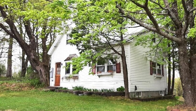 view of side of home featuring a yard