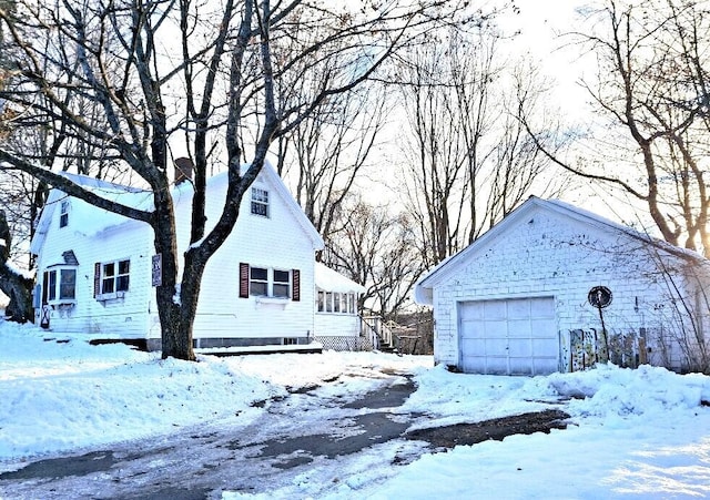 snow covered property featuring a garage