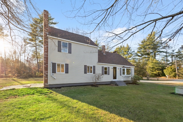 rear view of house featuring a yard