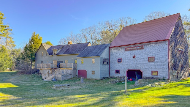 back of house featuring a yard and a wooden deck