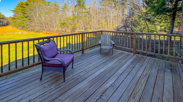 wooden terrace featuring a lawn