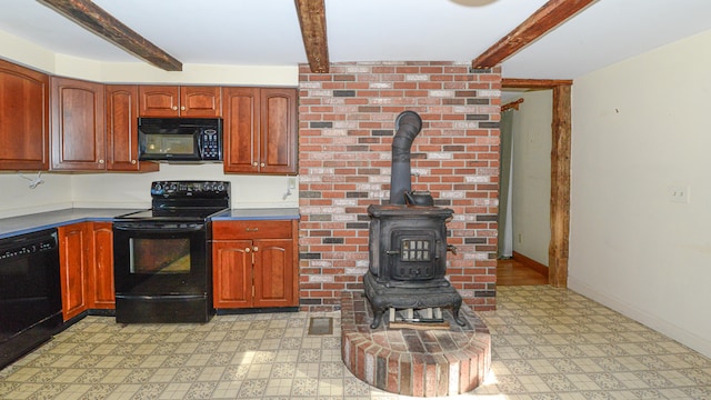 kitchen with beam ceiling, a wood stove, and black appliances