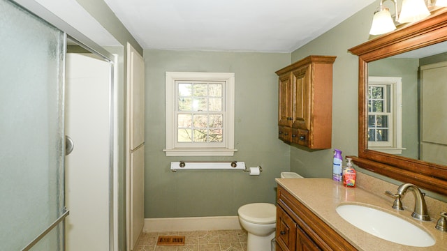 bathroom featuring tile patterned flooring, vanity, and toilet