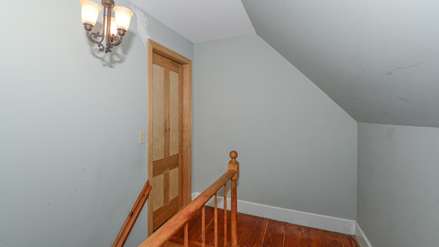 stairway featuring hardwood / wood-style floors and lofted ceiling