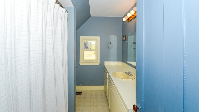 bathroom with vanity and vaulted ceiling