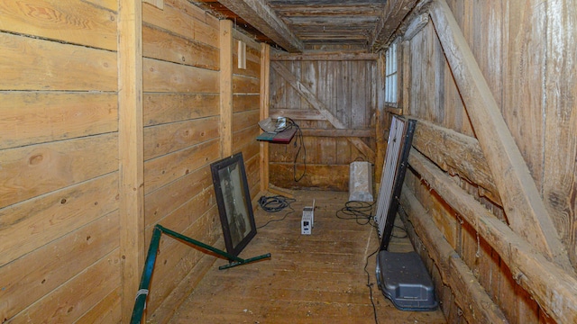 room details featuring wood-type flooring and wood walls