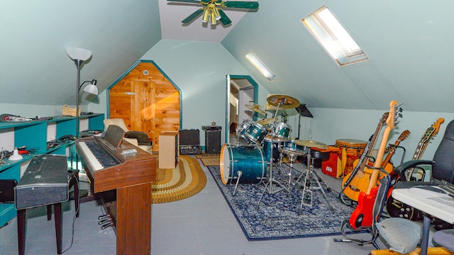 rec room with ceiling fan and vaulted ceiling with skylight