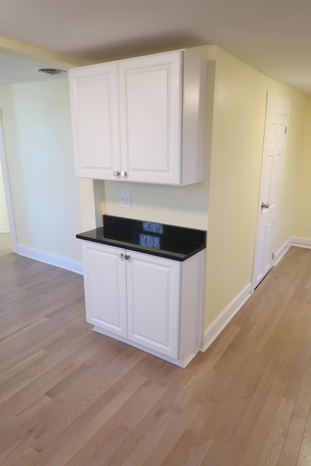 kitchen featuring light hardwood / wood-style flooring and white cabinets