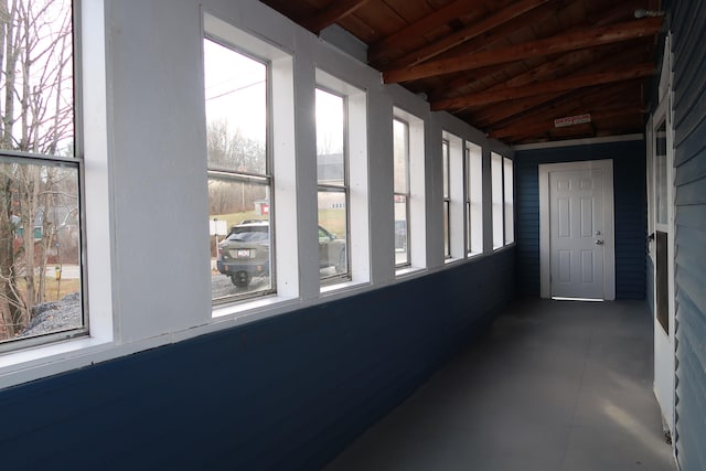 unfurnished sunroom with wood ceiling and lofted ceiling with beams