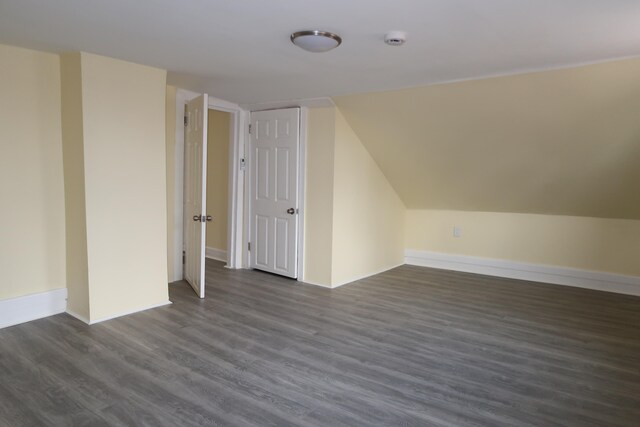 bonus room featuring dark hardwood / wood-style floors and vaulted ceiling