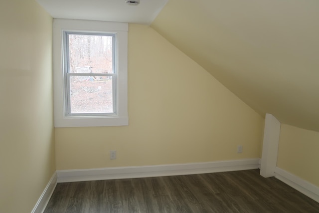 bonus room with dark hardwood / wood-style floors and lofted ceiling