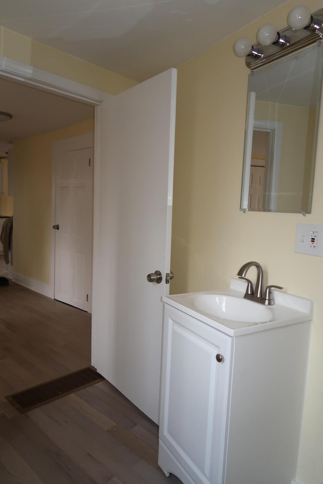 bathroom with hardwood / wood-style floors and vanity