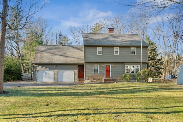 view of front of property featuring a garage and a front lawn