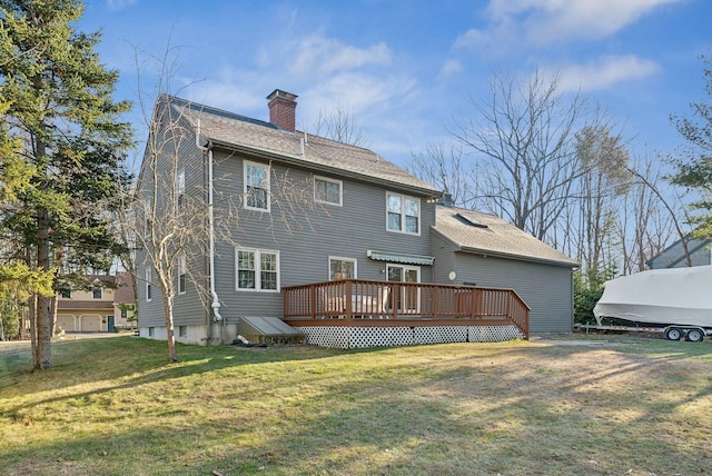 back of house featuring a lawn and a deck