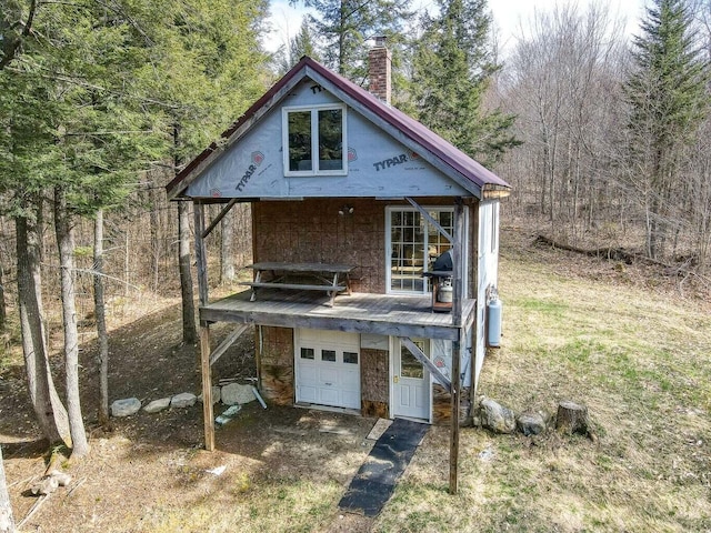 0 Little Huston Brook Rd, Concord Twp, ME 04920 - view of front of house featuring a chimney, driveway, a garage, and a wooded view