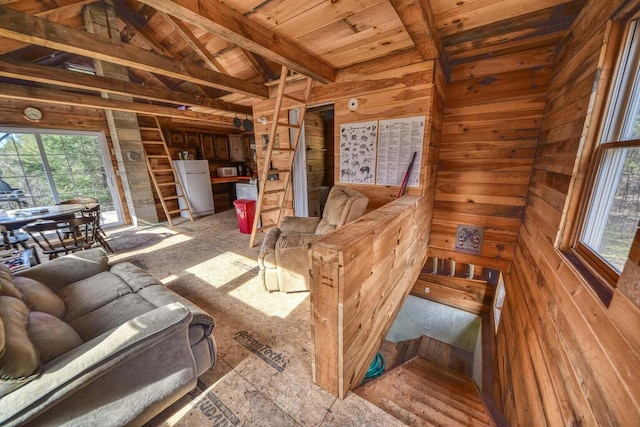 living room featuring wood walls and lofted ceiling