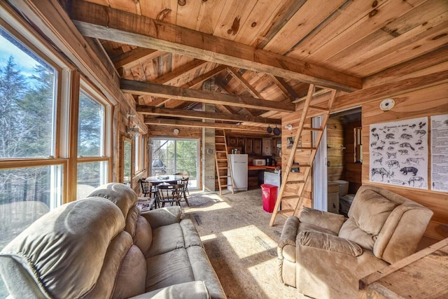 living room with wood walls, lofted ceiling with beams, and wooden ceiling