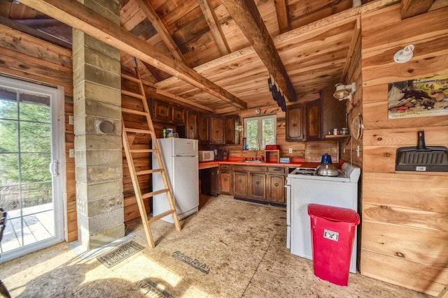 kitchen with white appliances, lofted ceiling with beams, sink, wooden walls, and wood ceiling