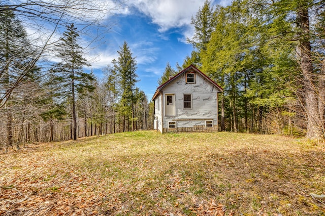 view of side of property with a lawn