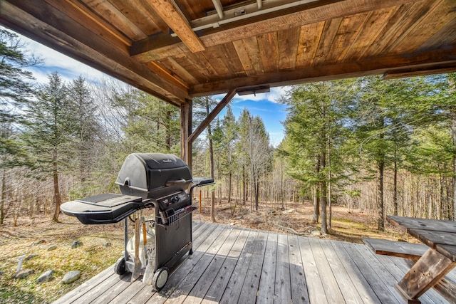 wooden deck featuring a grill