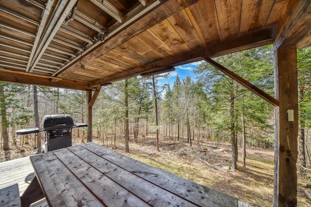 wooden terrace with a grill