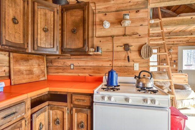 0 Little Huston Brook Rd, Concord Twp, ME 04920 - kitchen with white gas range oven, wooden ceiling with exposed beams, brown cabinets, and light countertops