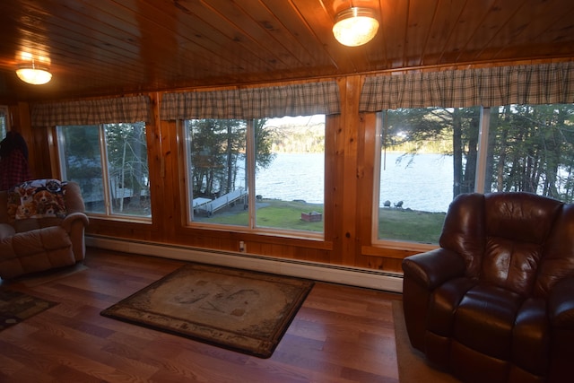 sunroom / solarium featuring wood ceiling, a water view, and a baseboard radiator