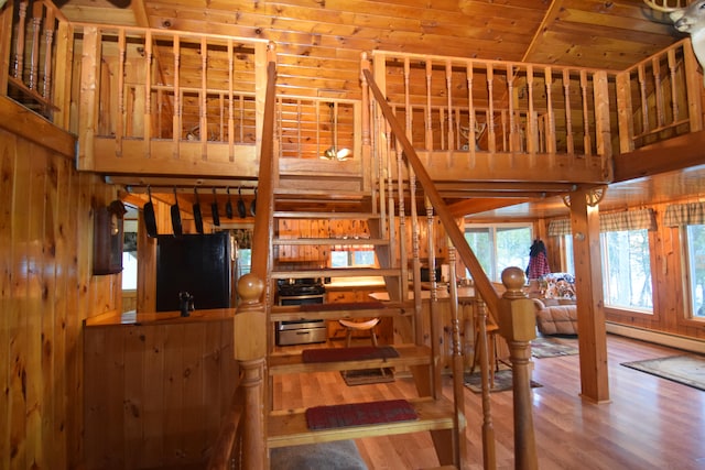 living room with wood walls, wood ceiling, and hardwood / wood-style flooring