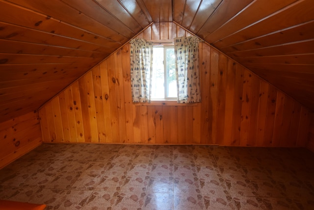 bonus room with vaulted ceiling, wooden ceiling, and wood walls