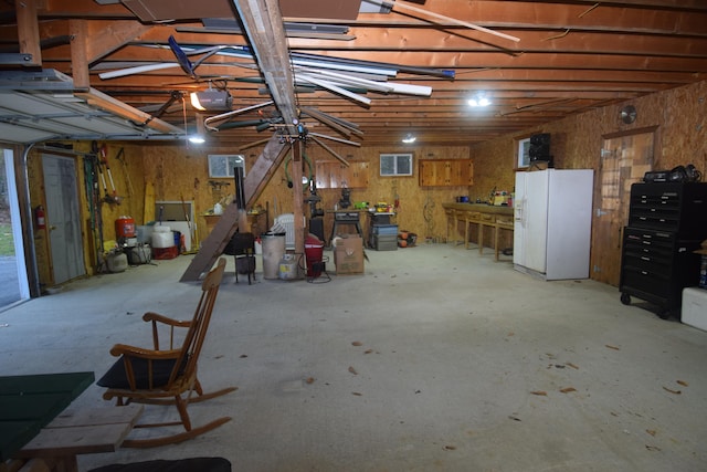 basement with white refrigerator with ice dispenser