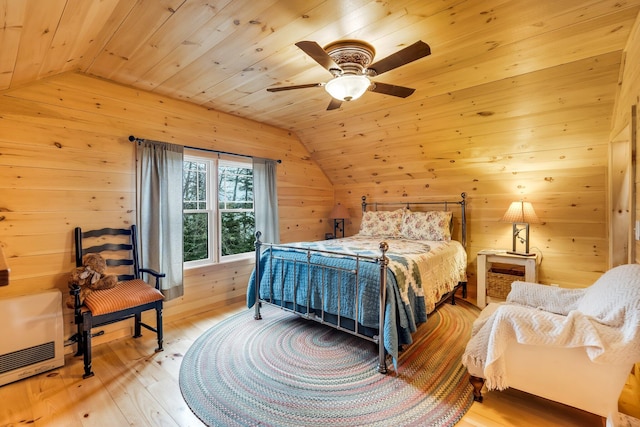 bedroom with ceiling fan, light hardwood / wood-style floors, lofted ceiling, and wood ceiling