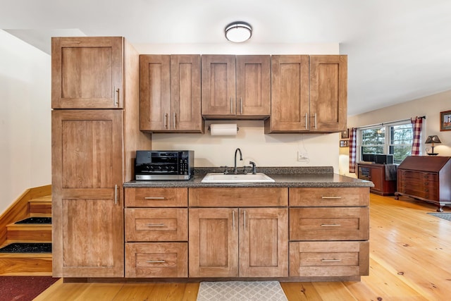 kitchen with sink and light hardwood / wood-style flooring