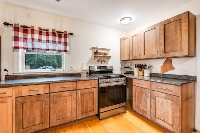 kitchen with gas stove and light hardwood / wood-style flooring