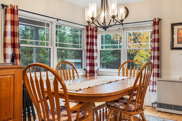 dining area with a chandelier and light hardwood / wood-style floors