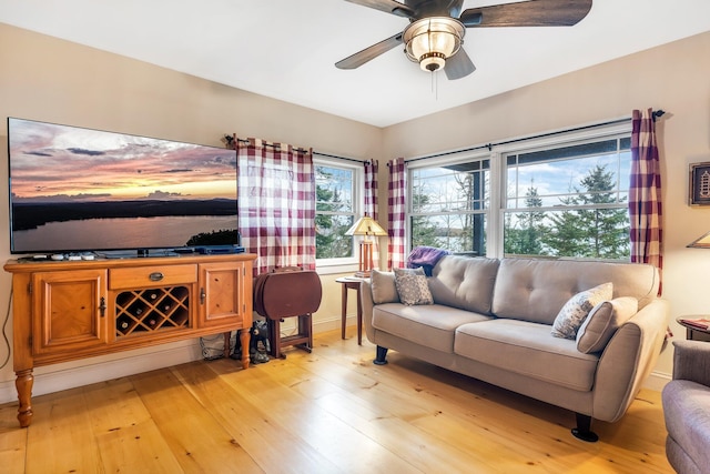 living room featuring ceiling fan and light wood-type flooring