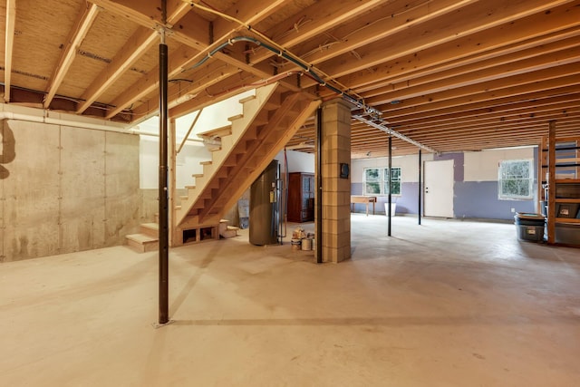 basement with a wealth of natural light and water heater