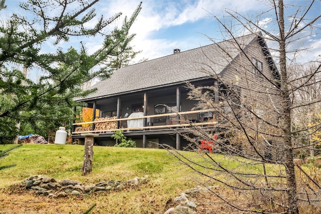 rear view of property with covered porch