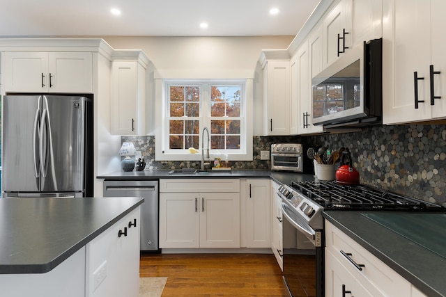11 Beacon Dr, Brunswick, ME 04011 - kitchen with white cabinets, sink, tasteful backsplash, light hardwood / wood-style floors, and stainless steel appliances